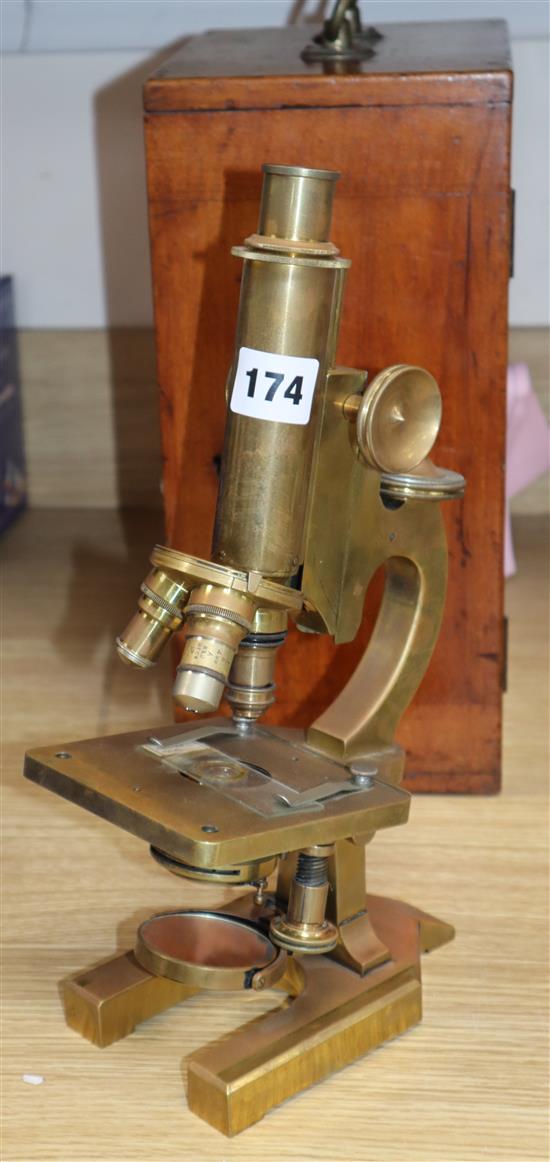 An early 20th century R & J Beck brass scientific microscope, mahogany cased